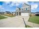 Charming two-story home with a well-maintained lawn and a two-car garage at 107 Cotton Blossom Way, Summerville, SC 29485