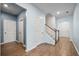 Hallway with hardwood floors and blue walls, showcasing access to various rooms and the staircase at 107 Cotton Blossom Way, Summerville, SC 29485