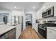 Modern kitchen featuring stainless steel appliances, white cabinetry, and a spacious island with sink at 107 Cotton Blossom Way, Summerville, SC 29485