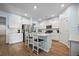 Bright kitchen features white cabinetry, stainless steel appliances, and a center island with seating at 107 Cotton Blossom Way, Summerville, SC 29485