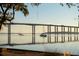 Picturesque waterfront view of a bridge and passing boats framed by oak trees at 108 Fairbanks Oak Aly # 302, Daniel Island, SC 29492