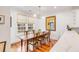 Bright dining room with wood floors, large windows, and traditional table with upholstered chairs at 108 Fairbanks Oak Aly # 302, Daniel Island, SC 29492