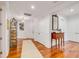 Bright hallway with hardwood floors, white trim, display shelves, and decorative table at 108 Fairbanks Oak Aly # 302, Daniel Island, SC 29492