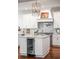 Kitchen island with wine fridge and marble countertops, stainless steel appliances, and decorative chandelier at 108 Fairbanks Oak Aly # 302, Daniel Island, SC 29492