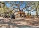 Spacious tree house and playground area with golf carts and a sign on a fenced lawn at 109 Loon Dr, Summerville, SC 29483