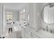 Bright, spacious bathroom featuring double sinks, a soaking tub, and large windows for natural light at 124 Beresford Creek St, Charleston, SC 29492