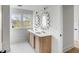 Bright bathroom featuring double vanity, quartz countertop, wood cabinets, and stylish mirrors at 124 Beresford Creek St, Charleston, SC 29492