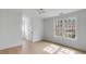 Bright bedroom with large windows, hardwood floors, white trim, and a modern light fixture at 124 Beresford Creek St, Charleston, SC 29492