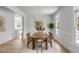 Bright and airy dining room with hardwood floors, modern decor, and large windows filling the space with light at 124 Beresford Creek St, Charleston, SC 29492