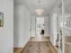 Bright, open foyer featuring hardwood floors, stylish lighting, and an inviting view into the home at 124 Beresford Creek St, Charleston, SC 29492