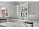 Bright kitchen with white cabinets, quartz countertops, stainless appliances, and a view to the backyard at 124 Beresford Creek St, Charleston, SC 29492