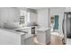 Bright open kitchen features white cabinetry, stainless appliances, kitchen island, and eat in nook at 124 Beresford Creek St, Charleston, SC 29492