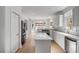 Open kitchen design with white cabinets, a large island, modern appliances, and hardwood floors at 124 Beresford Creek St, Charleston, SC 29492