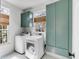 Bright laundry room includes washer, dryer, and storage cabinets at 124 Beresford Creek St, Charleston, SC 29492