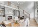 Spacious living room with a cozy fireplace, built-in bookshelves, and staircase leading to upper level at 124 Beresford Creek St, Charleston, SC 29492