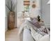 Bright living space featuring a plush sofa, textured throw blanket, and tall decorative wicker vase at 124 Beresford Creek St, Charleston, SC 29492