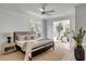 Relaxing main bedroom features a ceiling fan and attached sitting room with ample natural light at 124 Beresford Creek St, Charleston, SC 29492