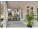 Inviting covered porch with a comfortable swing, stylish lighting, and a charming outdoor space at 124 Beresford Creek St, Charleston, SC 29492