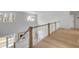 Bright foyer with a wooden staircase and large windows illuminating light hardwood floors at 124 Beresford Creek St, Charleston, SC 29492