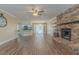 Spacious living room with wood-look flooring, a brick fireplace, and views of the kitchen at 124 Knightsbridge Dr, North Charleston, SC 29418