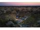 Twilight aerial of a residential neighborhood featuring tree-lined streets and well-maintained homes at 1327 Bob White Dr, Charleston, SC 29412