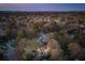 Overhead view of a vibrant neighborhood showcasing cozy homes and lush trees at dusk at 1327 Bob White Dr, Charleston, SC 29412