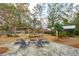 Inviting backyard with stone patio, fire pit, and pergola, perfect for outdoor entertaining and relaxation at 1327 Bob White Dr, Charleston, SC 29412
