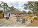Spacious backyard features stone patio with fire pit and seating, ideal for gatherings and enjoying the outdoors at 1327 Bob White Dr, Charleston, SC 29412