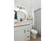 Bathroom with a stylish vanity, round mirror, shiplap accent wall, and a shower with a modern striped curtain at 1327 Bob White Dr, Charleston, SC 29412