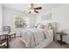 Bright bedroom with a ceiling fan, a neutral color palette, and a sunlit window that offers a pleasant view at 1327 Bob White Dr, Charleston, SC 29412
