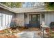 Stylish front entry with a dark-colored door, decorative wreath, and curated landscaping at 1327 Bob White Dr, Charleston, SC 29412