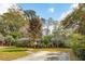 A well-maintained house, with manicured lawn, mature trees, and a long concrete driveway at 1327 Bob White Dr, Charleston, SC 29412