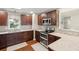 Well-equipped kitchen with dark wood cabinets, stainless steel appliances, and granite countertops at 1327 Bob White Dr, Charleston, SC 29412