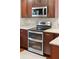 Close up view of stainless steel double oven and microwave with dark wood cabinetry at 1327 Bob White Dr, Charleston, SC 29412