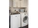 Functional laundry area with modern white machines and above storage for organized convenience at 1327 Bob White Dr, Charleston, SC 29412