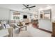 Open-concept living and dining areas featuring hardwood floors, large windows, and ceiling fan at 1327 Bob White Dr, Charleston, SC 29412