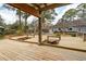 Beautiful pergola features built-in benches and a serene backyard view, providing a peaceful outdoor retreat at 1327 Bob White Dr, Charleston, SC 29412