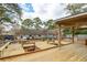 Spacious wooden deck featuring built-in seating and a shaded pergola, ideal for backyard relaxation and entertaining at 1327 Bob White Dr, Charleston, SC 29412