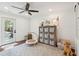 Bright play room with ship lap wall, decorative shelving, a modern ceiling fan, and access to the outside at 1327 Bob White Dr, Charleston, SC 29412
