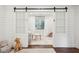 Sun-filled sitting room framed by modern barn doors and featuring soft light, neutral colors, and comfortable seating at 1327 Bob White Dr, Charleston, SC 29412