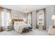 Comfortable main bedroom featuring large windows, neutral tones, and a decorative chandelier, creating a relaxing atmosphere at 1441 Clay Field Trl, Summerville, SC 29485