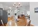 Dining area adjacent to the kitchen with wood floors and decorative chandelier lighting at 150 Etiwan Park St, Charleston, SC 29492