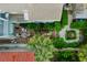 Aerial view of a beautifully landscaped backyard with brick patio, pergola, fountain, and seating areas at 157 Tradd St, Charleston, SC 29401