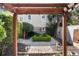 Picturesque backyard with a tranquil fountain as a focal point, framed by a wooden pergola at 157 Tradd St, Charleston, SC 29401