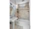 Cozy bathroom featuring a shower over the bathtub with tiled walls at 157 Tradd St, Charleston, SC 29401