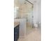 Modern bathroom with a glass shower, stylish tile, and blue vanity at 157 Tradd St, Charleston, SC 29401