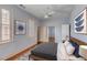 Cozy guest bedroom featuring a ceiling fan, neutral walls, wood floors, and comfortable bed at 157 Tradd St, Charleston, SC 29401
