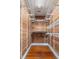 Walk in closet with white metal shelving and cedar planks for backing at 157 Tradd St, Charleston, SC 29401