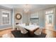 Elegant dining room featuring a modern table, chandelier, and fireplace at 157 Tradd St, Charleston, SC 29401
