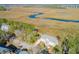 Beautiful aerial view of coastal home, private dock, and marsh with waterway access to the ocean at 1602 John Fenwick Ln, Johns Island, SC 29455